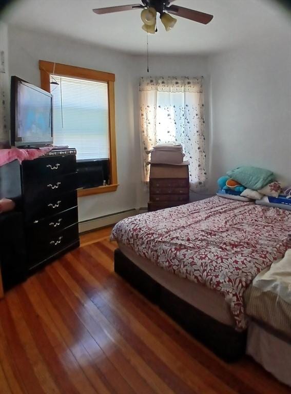 347 Summer St, Lynn, MA 01905 - bedroom with multiple windows, a baseboard heating unit, wood finished floors, and ceiling fan
