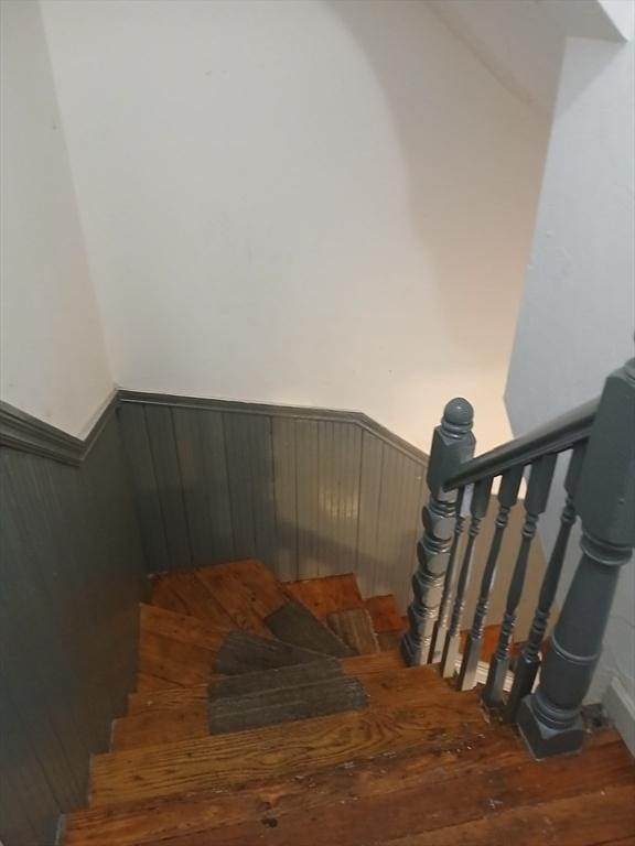 347 Summer St, Lynn, MA 01905 - staircase with wood finished floors and a wainscoted wall