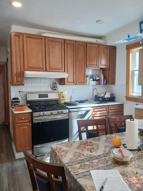 347 Summer St, Lynn, MA 01905 - kitchen with stainless steel appliances, under cabinet range hood, brown cabinetry, light countertops, and recessed lighting