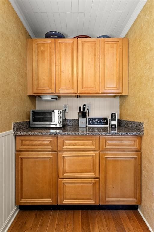 85 Flint St, Salem, MA 01970 - kitchen with dark wood-style floors, crown molding, and dark stone countertops