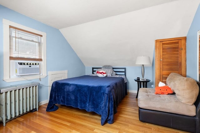 85 Flint St, Salem, MA 01970 - bedroom featuring radiator heating unit, wood finished floors, lofted ceiling, and cooling unit