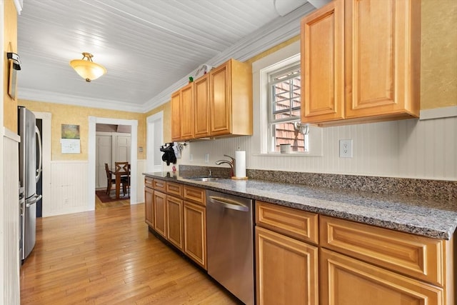 85 Flint St, Salem, MA 01970 - kitchen featuring appliances with stainless steel finishes, light wood-style flooring, a wainscoted wall, dark stone countertops, and ornamental molding