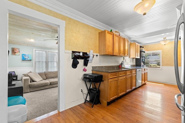85 Flint St, Salem, MA 01970 - kitchen featuring stainless steel appliances, wainscoting, light wood finished floors, dark countertops, and ornamental molding