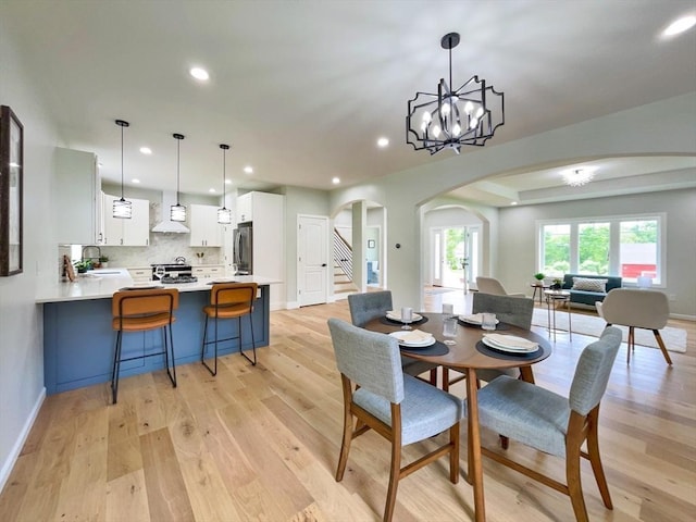 101 N Rd, Westfield, MA 01085 - dining area featuring arched walkways, recessed lighting, light wood-style floors, stairs, and a chandelier