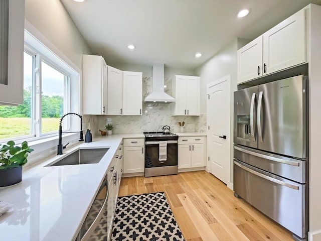 101 N Rd, Westfield, MA 01085 - kitchen with stainless steel appliances, wall chimney exhaust hood, decorative backsplash, light countertops, and white cabinetry