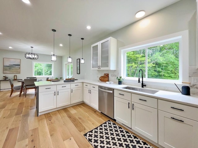 101 N Rd, Westfield, MA 01085 - kitchen with stainless steel dishwasher, a peninsula, light wood-style flooring, glass insert cabinets, and white cabinets
