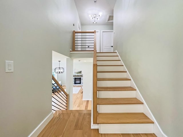 101 N Rd, Westfield, MA 01085 - staircase with a chandelier, a fireplace, and wood finished floors