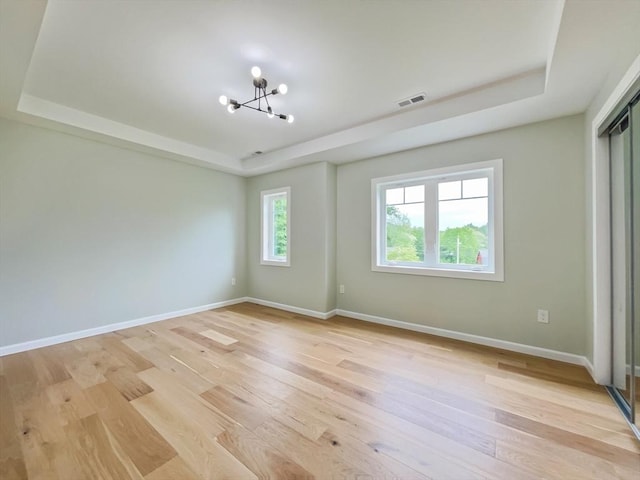 101 N Rd, Westfield, MA 01085 - spare room featuring a raised ceiling, a chandelier, and light wood-type flooring