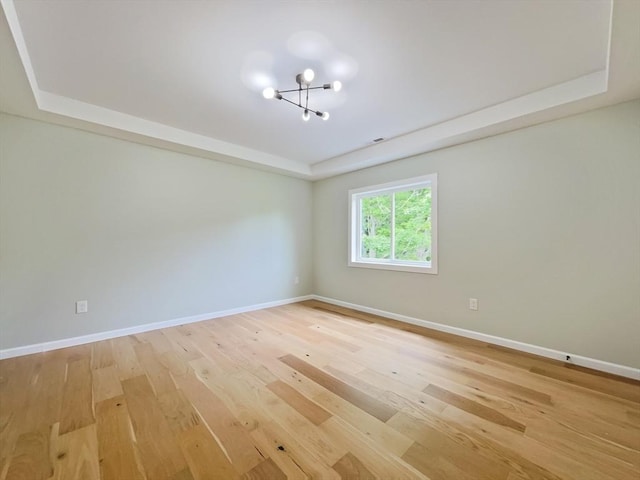 101 N Rd, Westfield, MA 01085 - spare room featuring a tray ceiling, a chandelier, and light wood-style floors