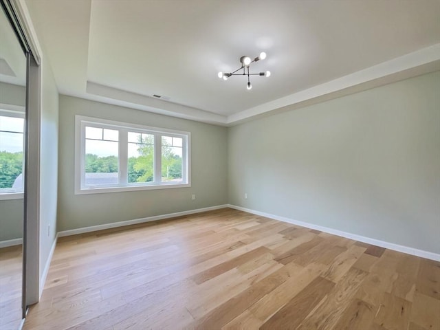101 N Rd, Westfield, MA 01085 - unfurnished room with a chandelier, a tray ceiling, and light wood-type flooring