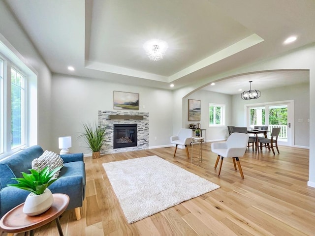 101 N Rd, Westfield, MA 01085 - living room with arched walkways, a tray ceiling, a glass covered fireplace, light wood-style flooring, and recessed lighting