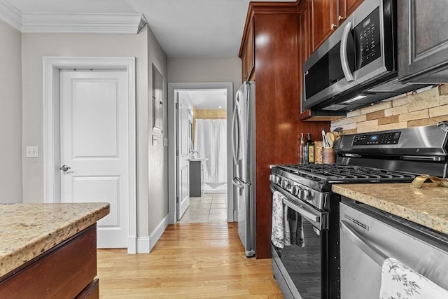 10 Mitchell St Unit 3, Boston, MA 02127 - kitchen featuring stainless steel appliances, light wood-type flooring, backsplash, crown molding, and light stone counters