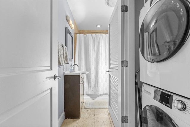 10 Mitchell St Unit 3, Boston, MA 02127 - laundry area featuring stacked washer / dryer and baseboards