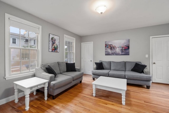 living room with light wood-type flooring and baseboards