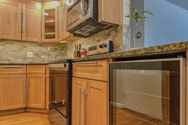 50 Green St Unit 312, Brookline, MA 02446 - kitchen with stainless steel microwave, wine cooler, light wood-style floors, and decorative backsplash