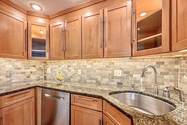 50 Green St Unit 312, Brookline, MA 02446 - kitchen with stainless steel dishwasher, glass insert cabinets, dark stone counters, and tasteful backsplash