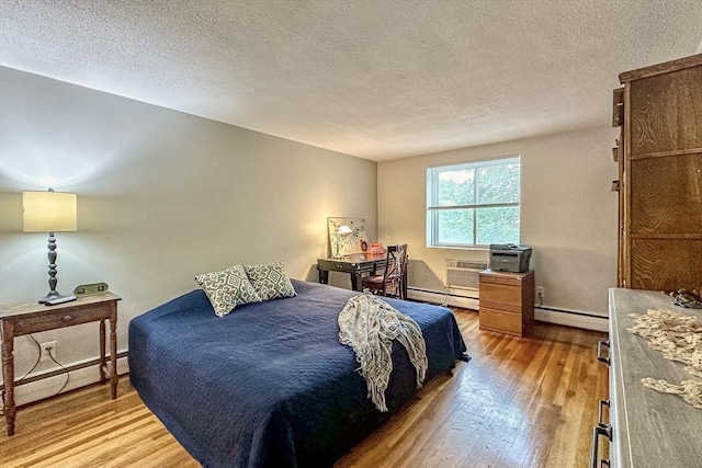 50 Green St Unit 312, Brookline, MA 02446 - bedroom with baseboard heating, wood finished floors, and a textured ceiling