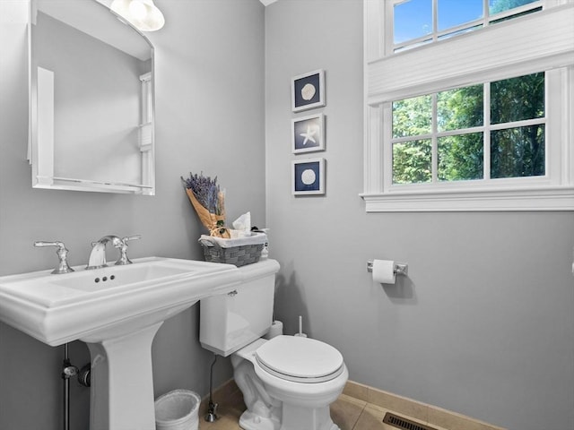23 Chandler St, Newton, MA 02458 - half bath with toilet, plenty of natural light, baseboards, and tile patterned floors