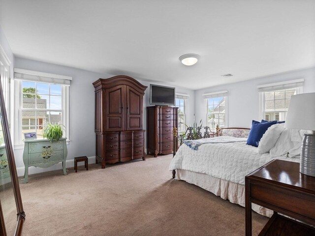 23 Chandler St, Newton, MA 02458 - bedroom featuring multiple windows, light colored carpet, and baseboards