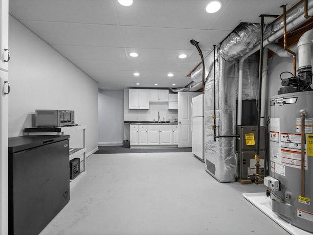 23 Chandler St, Newton, MA 02458 - basement featuring gas water heater, freestanding refrigerator, recessed lighting, a sink, and refrigerator
