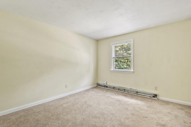 unfurnished room with a baseboard heating unit, carpet, and baseboards