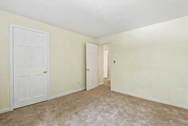 unfurnished bedroom featuring baseboards and carpet flooring