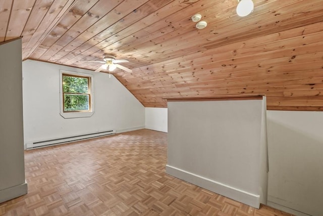 additional living space featuring baseboards, lofted ceiling, and a baseboard radiator