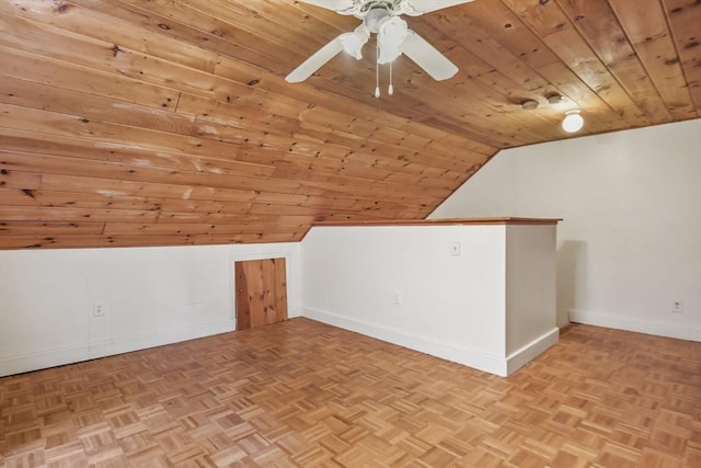 additional living space with parquet floors, baseboards, wood ceiling, ceiling fan, and vaulted ceiling