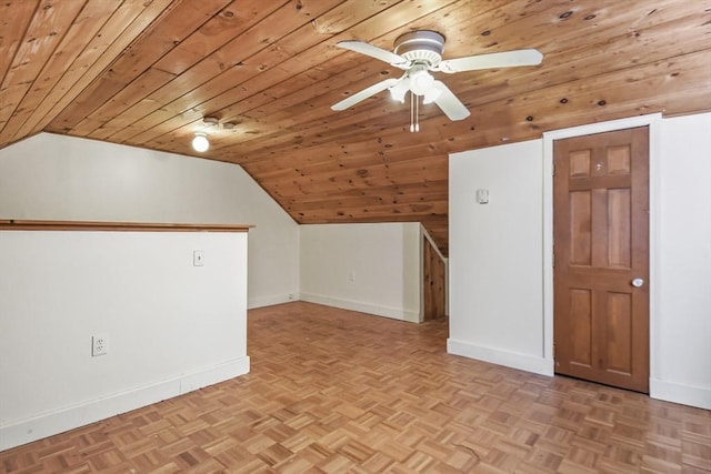 additional living space featuring parquet flooring, a ceiling fan, baseboards, and vaulted ceiling