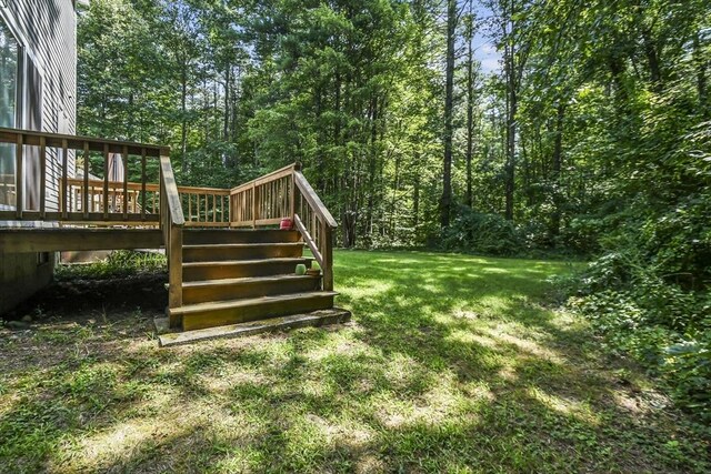 view of yard with stairs and a wooden deck