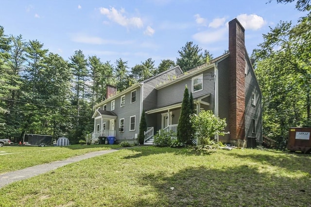 view of front of property featuring a front lawn and a chimney