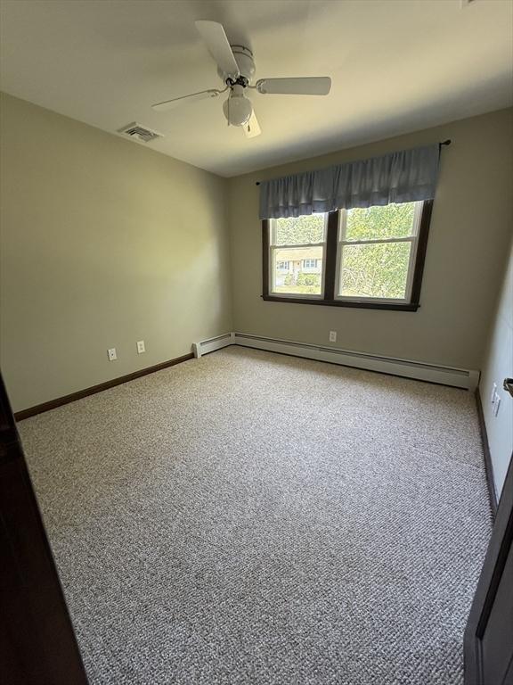 69 Hickory Dr, Raynham, MA 02767 - empty room featuring light carpet, a ceiling fan, and baseboard heating