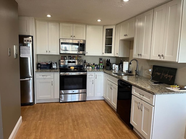 36 Bayview Ter Unit 11, Danvers, MA 01923 - kitchen with appliances with stainless steel finishes, a sink, light wood-style flooring, white cabinetry, and recessed lighting