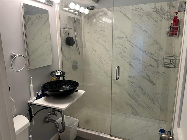 36 Bayview Ter Unit 11, Danvers, MA 01923 - bathroom featuring a marble finish shower, toilet, and a sink