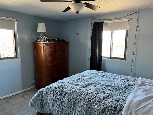 36 Bayview Ter Unit 11, Danvers, MA 01923 - bedroom with multiple windows, carpet floors, a ceiling fan, and baseboards