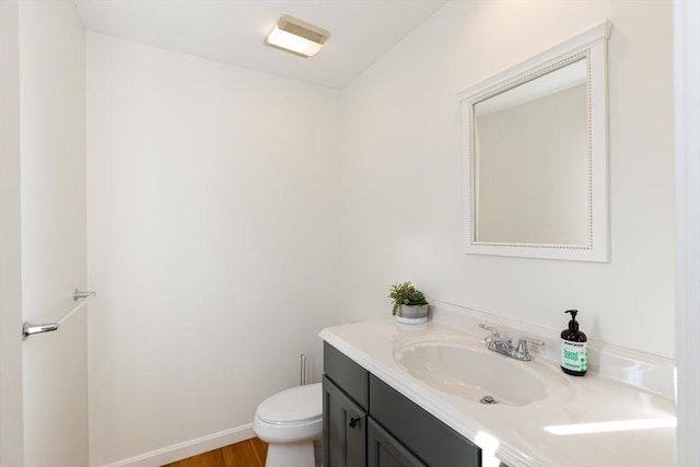 bathroom featuring vanity, toilet, and wood-type flooring