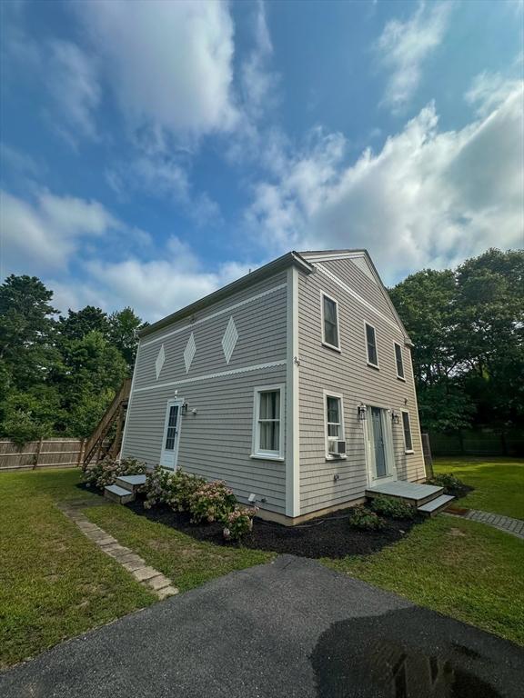 view of side of home with a lawn