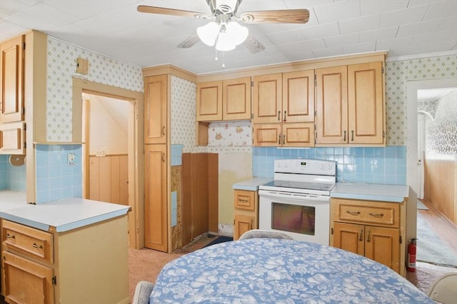 kitchen with wallpapered walls, light brown cabinets, light countertops, and electric stove