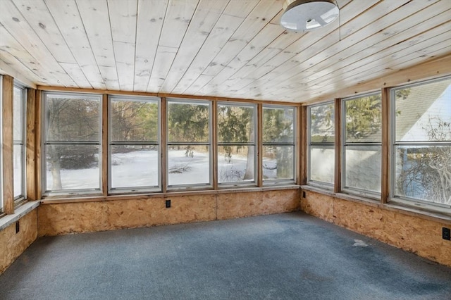 unfurnished sunroom featuring a healthy amount of sunlight and wooden ceiling