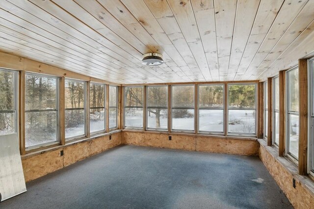 unfurnished sunroom with wooden ceiling and plenty of natural light