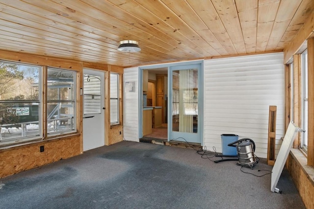 unfurnished sunroom with wood ceiling and a healthy amount of sunlight