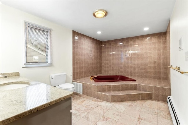 bathroom featuring visible vents, baseboard heating, vanity, toilet, and tiled bath
