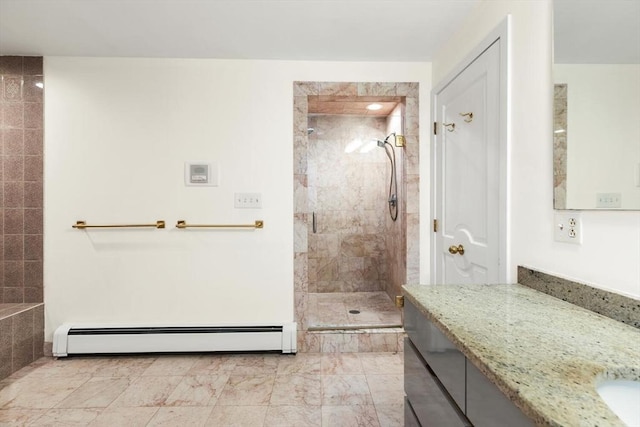 full bathroom with vanity, a baseboard radiator, and tiled shower