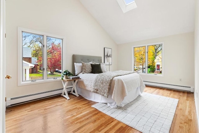 bedroom featuring a baseboard radiator and multiple windows