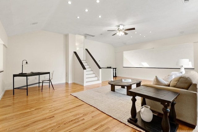 living area with stairs, ceiling fan, recessed lighting, light wood finished floors, and vaulted ceiling