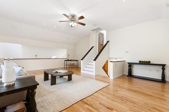 living room with a ceiling fan, light wood-style flooring, and lofted ceiling