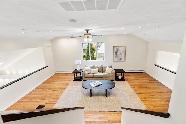 living room with recessed lighting, a ceiling fan, a baseboard heating unit, and light wood finished floors