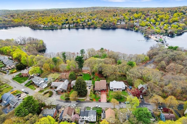 birds eye view of property with a water view, a residential view, and a wooded view