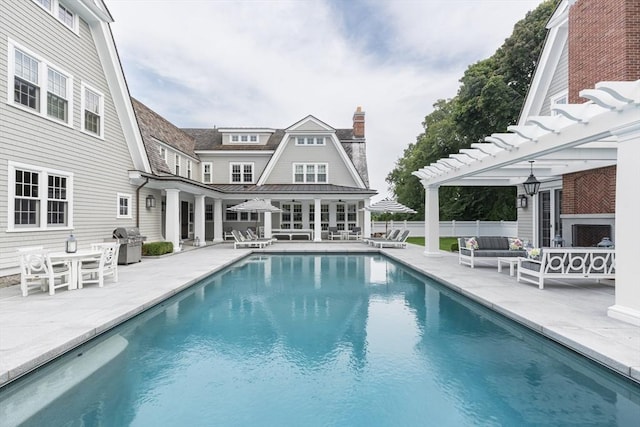 view of swimming pool with grilling area, a pergola, an outdoor living space, and a patio area