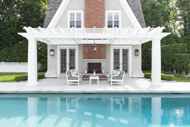 rear view of property featuring a pergola, fence, french doors, and a patio